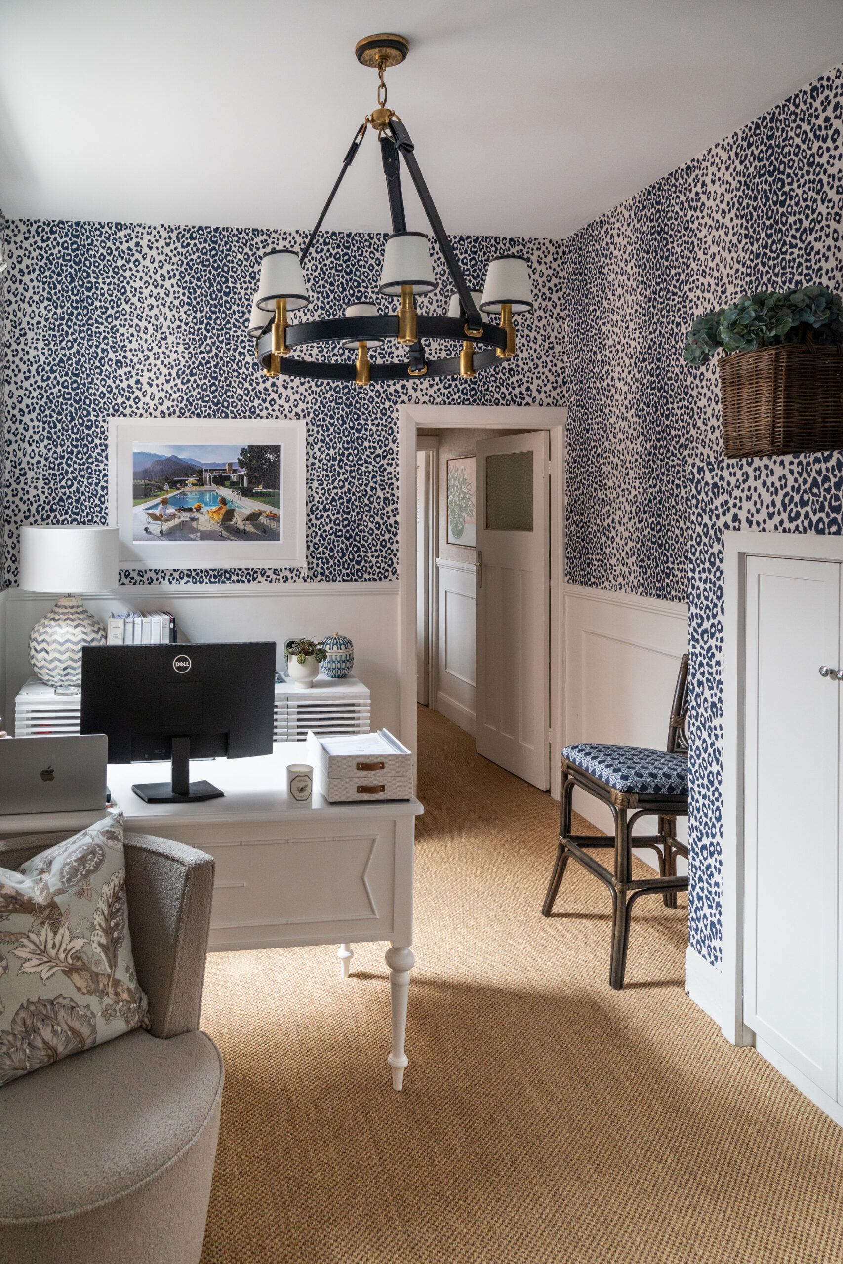 Interior design studio in Canterbury featuring leopard print wallpaper and a Ralph Lauren pendant. 