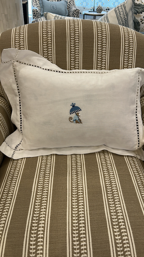 Monogram cushion on a classic style armchair