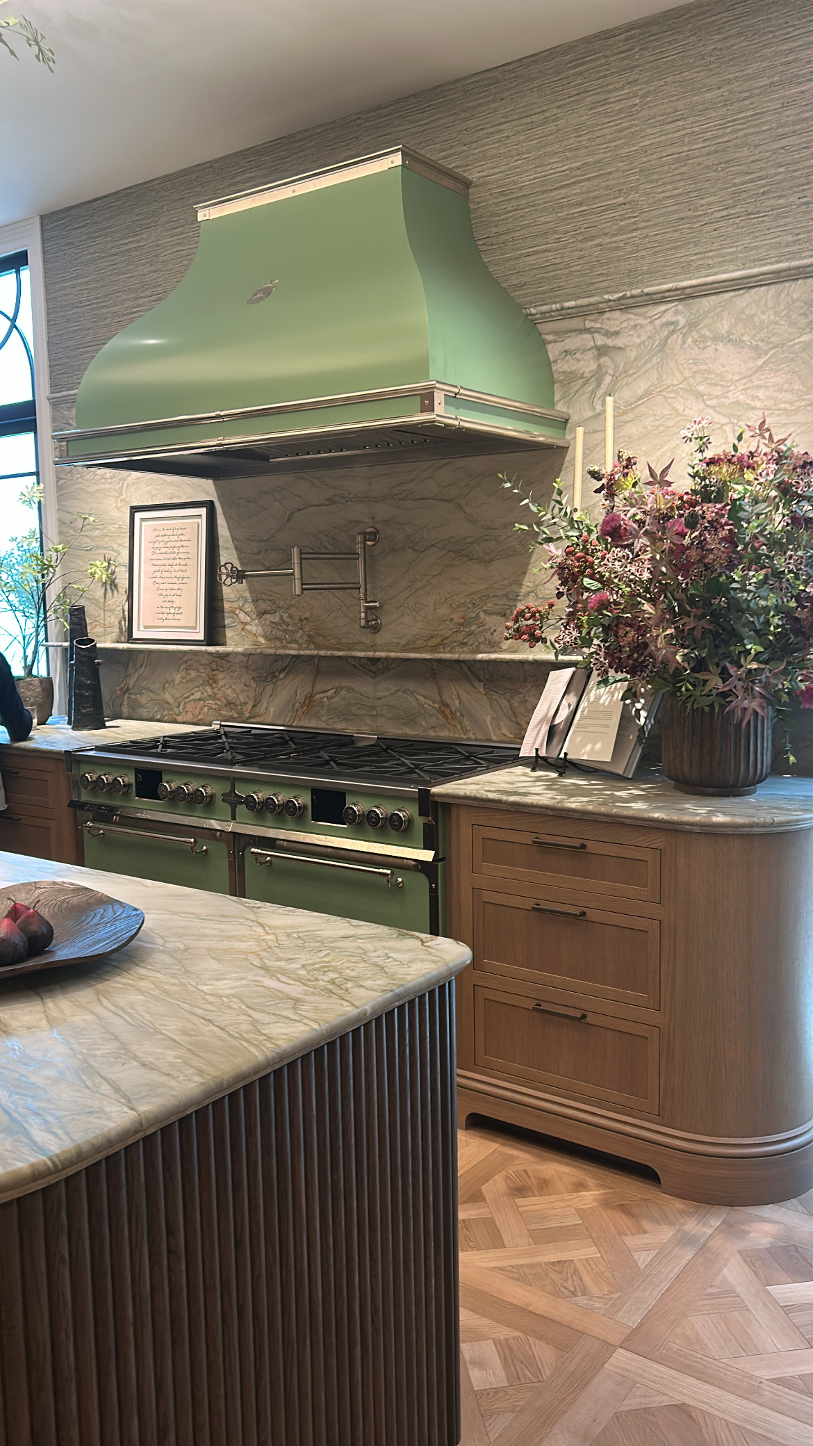Green rangehood and cooker in this timeless kitchen at Wow!House London